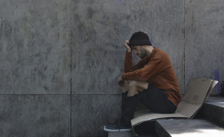 homeless-man-sitting-sideways-cardboard-770x470